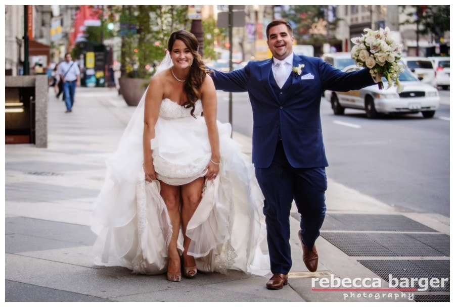 A just married bride and groom celebrate the end of their photography session and head to their reception at Cescaphe's Down Town Club, flowers by Beautiful Blooms.