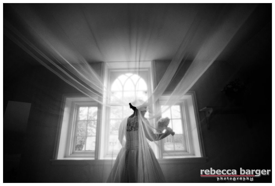 Love this photo of Kiera right after she finished dressing in her childhood home, wedding gown and veil by Pronovias from Van Cleve Bridal.