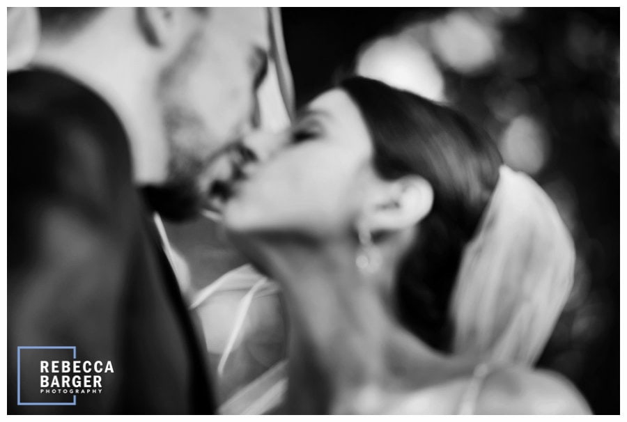 The couple share a kiss at Finley Catering's Ballroom at Ellis Preserve.