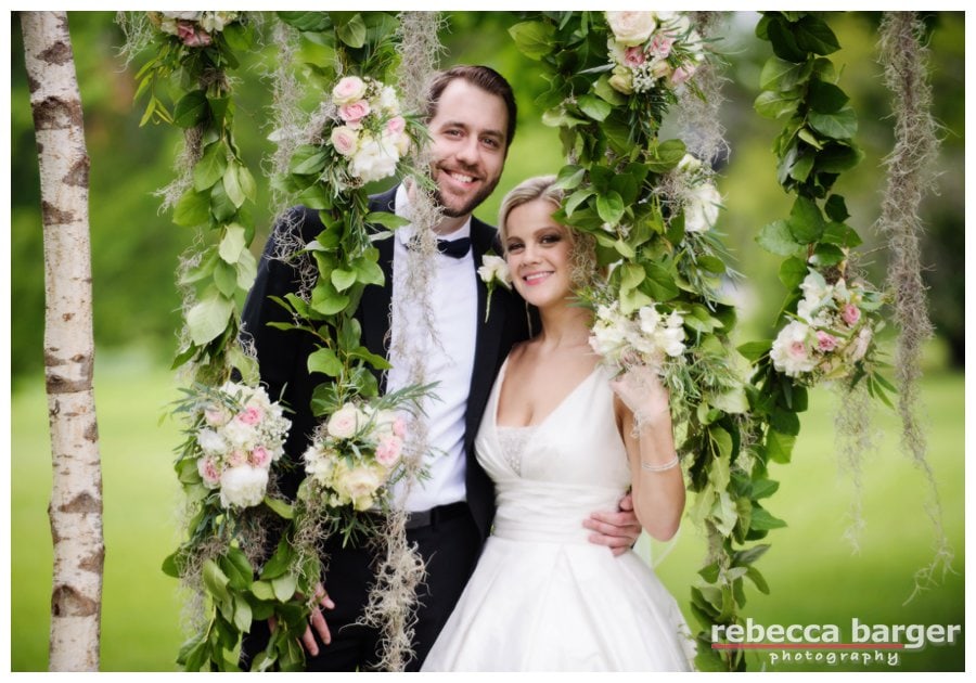 Cascading flowers decorate the archway that the couple exchanges their vows, designed by Margaux St. Ledger of Fleur de lis Floral.