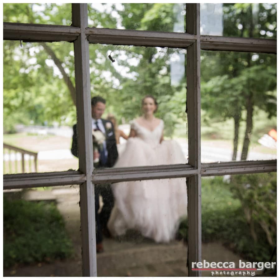 Love this image of Becca and Dave through the original rustic glass at Hotel du Village.
