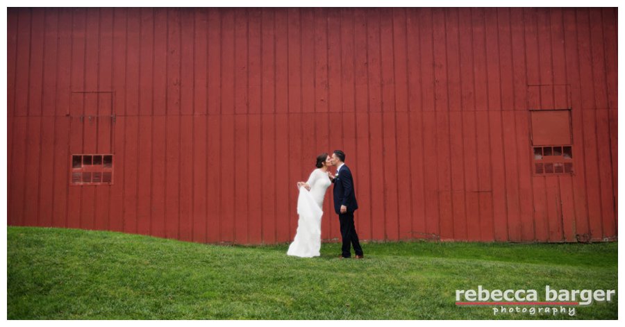 A sweet, little kiss near the barn at The Cricket Club.