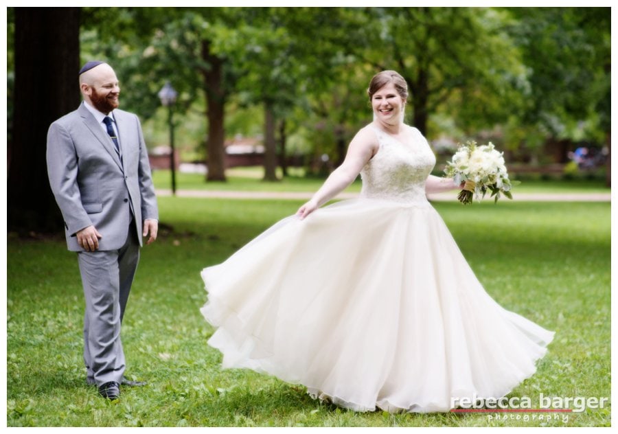 Katie shows Jordan that gown in motion, flowers by Sommerfield Designs.