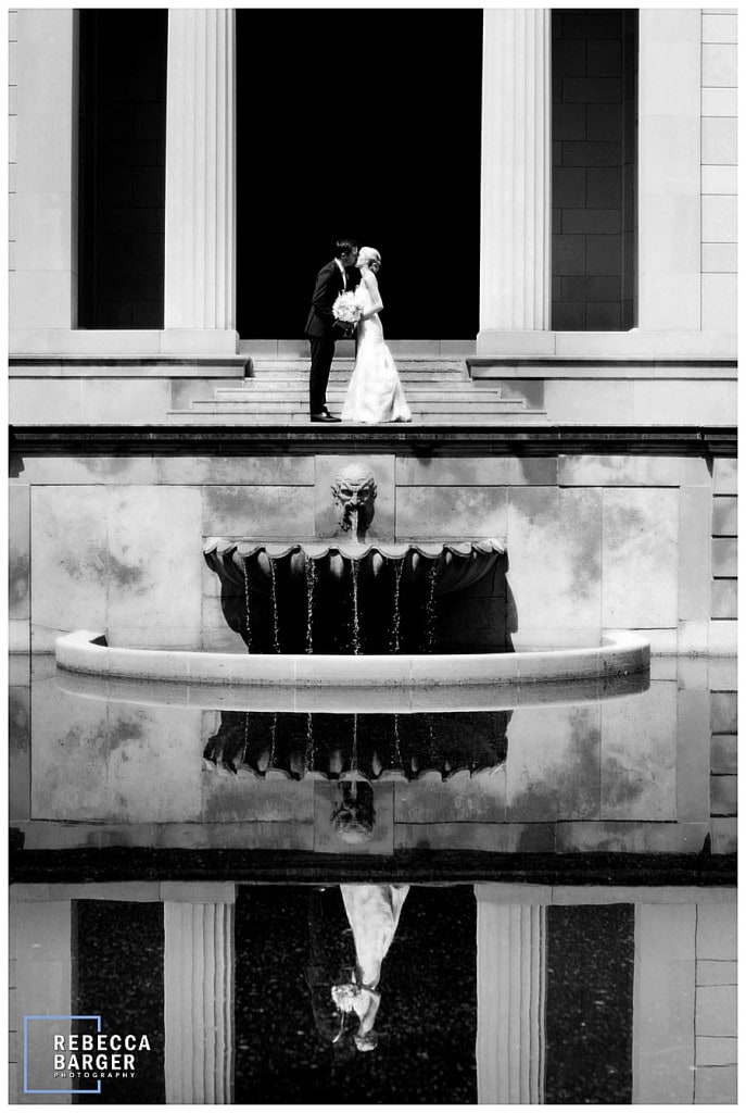 Appearing as part of the architecture, Lauren and James share a kiss at The Rodin Museum, Rebecca Barger Photography.